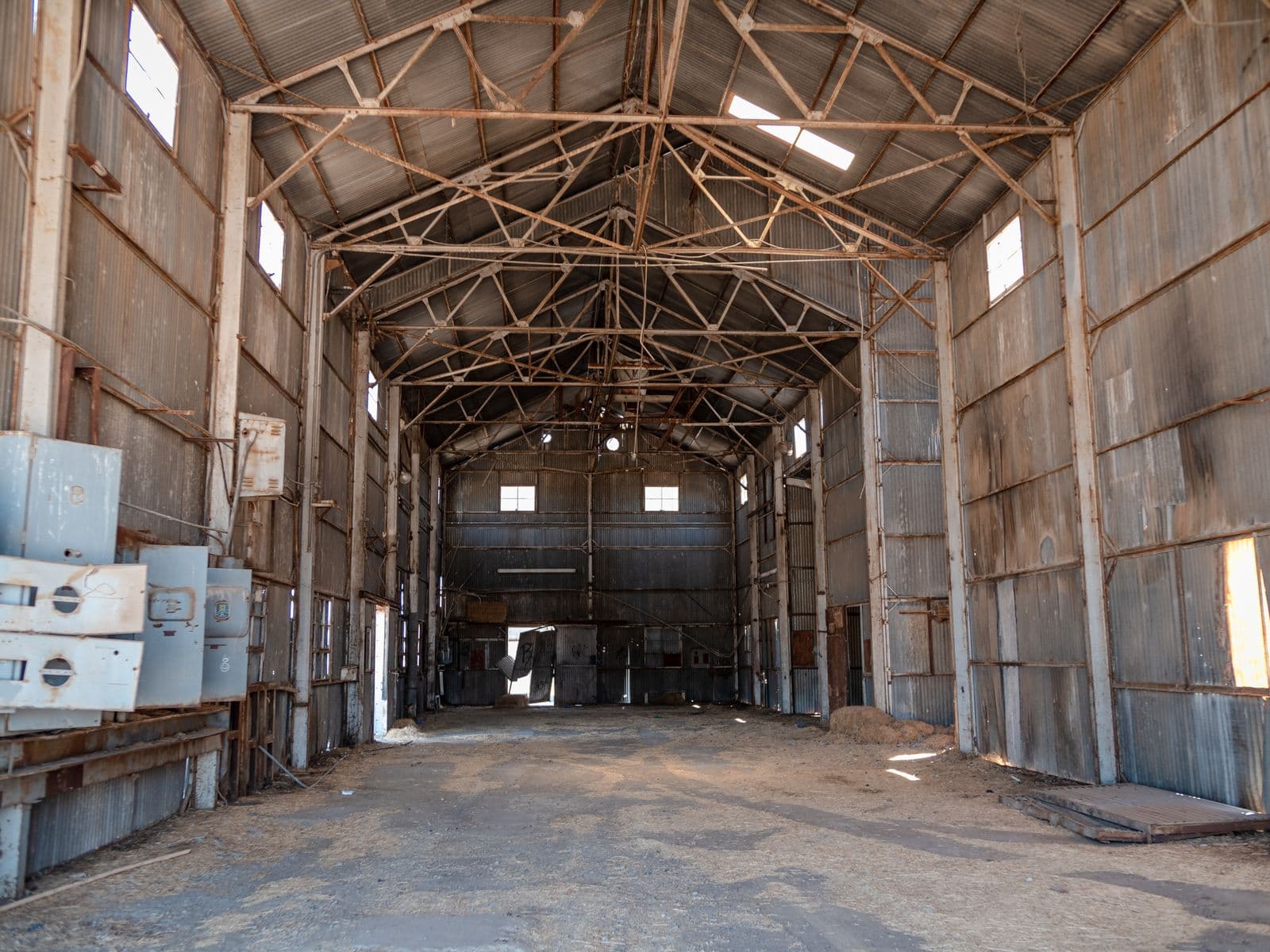 Worn, stained garage interior with a deteriorated floor surface awaiting diagnosis